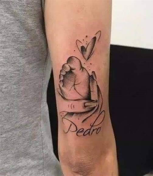 Tattoos of Mothers for Children on the skin and in the heart holding the little foot of the child Pedro