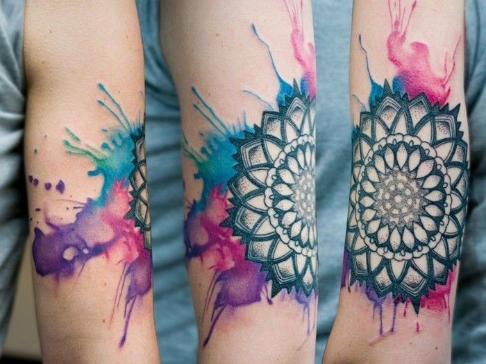Mandala-Tattoos in Aquarellflecken auf dem Arm