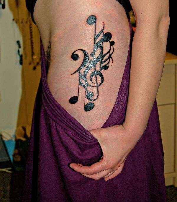 Music Tattoos Great Work on Nehro with Overlapping Musical Notes