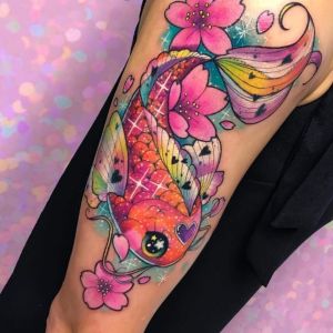 Multicolored fish with flowers tattoos