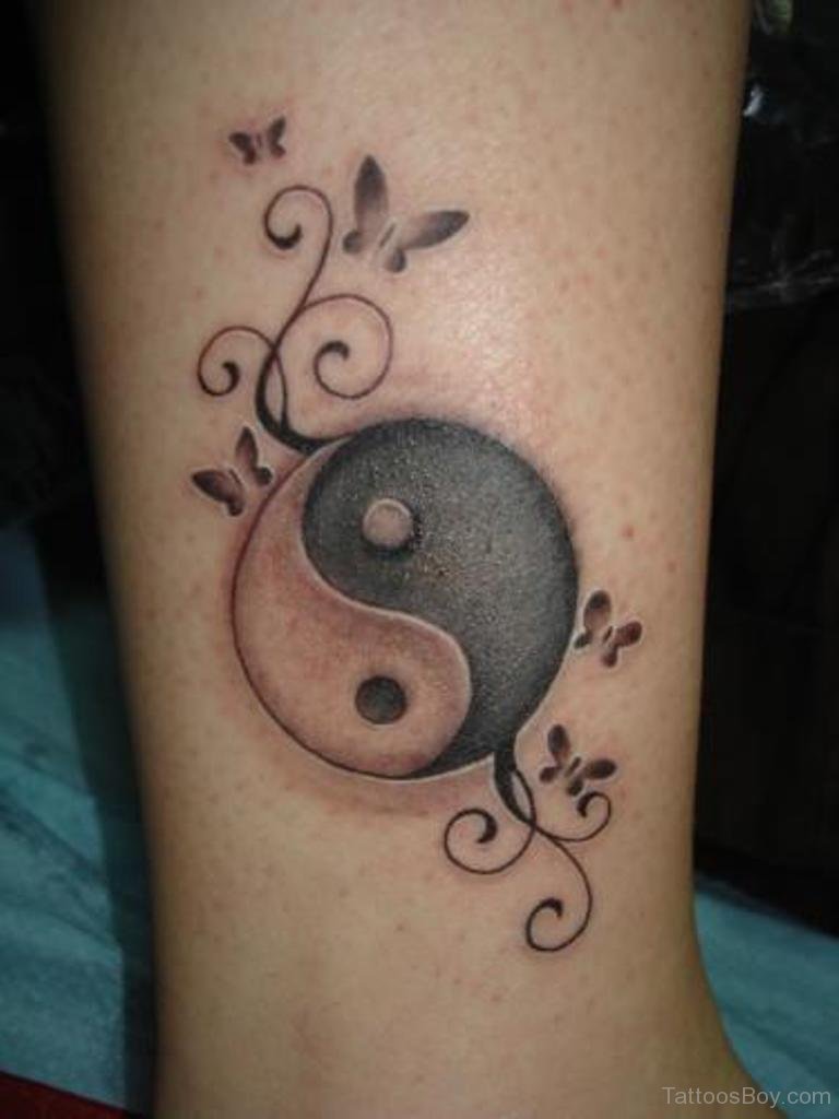 Tatuajes de Yin Yang con adornos y mariposas en pantorrilla