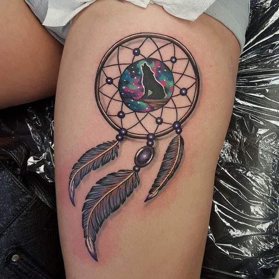 Dreamcatcher tattoos angel callers with circle and wolf on the mid-thigh