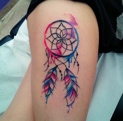 Angel caller dreamcatcher tattoos in vivid shades of fuchsia and light blue on the thigh with two feathers