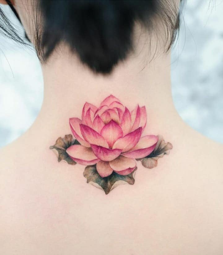 Tattoos of delicate colorful lotus flowers at the base of the neck