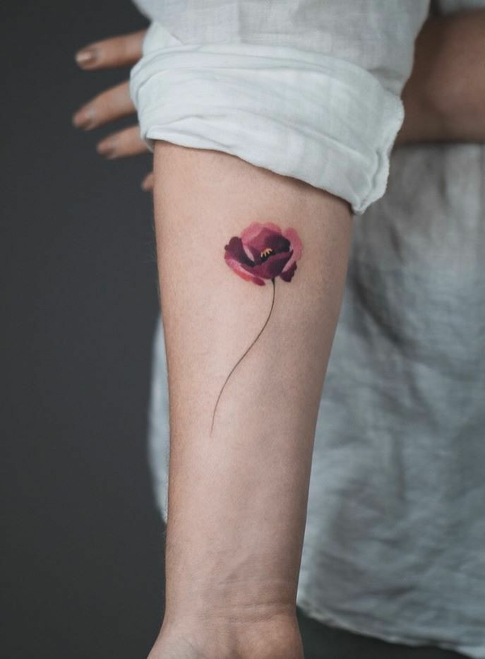 Red flower tattoos with fine Poppy petals on forearm
