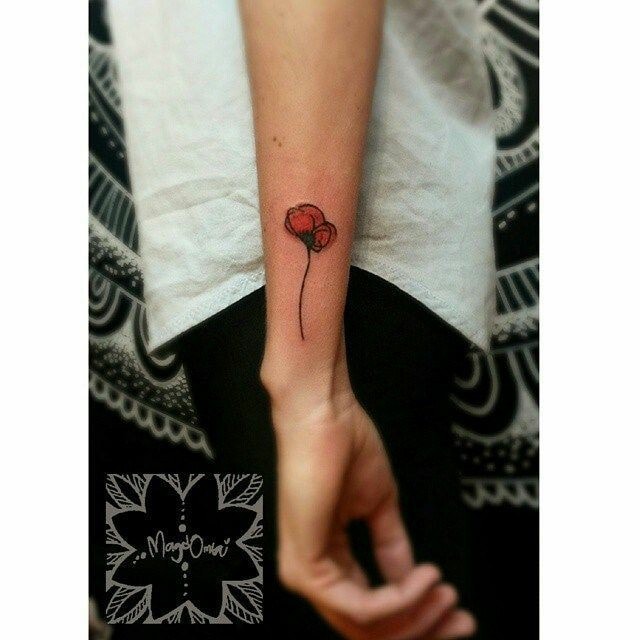Small red flower tattoos with fine poppy petals on the side of the arm