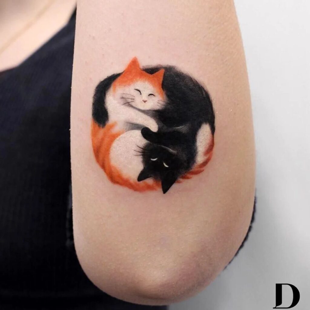 Tattoos of beautiful cats, yin and yang represented with an orange cat and a black cat