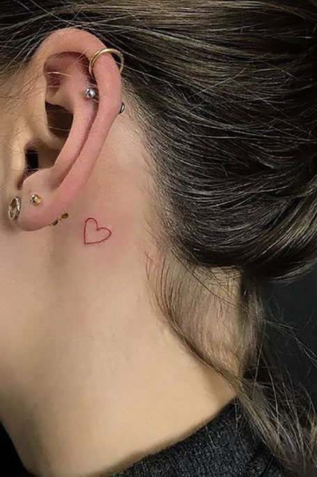 Tattoos behind the ears small red heart outline
