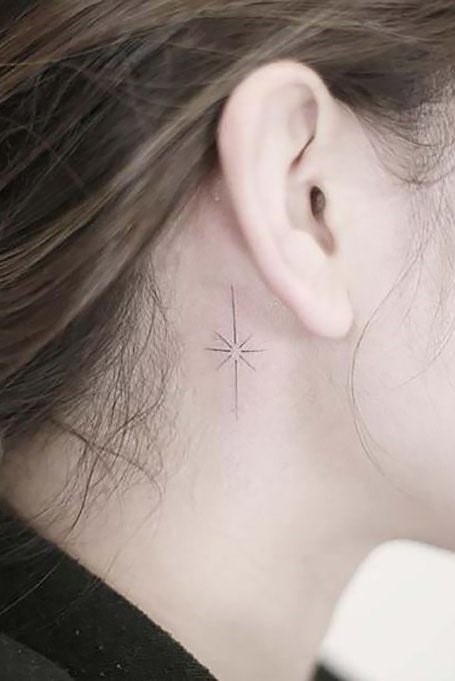 Tattoos behind the ears elongated star