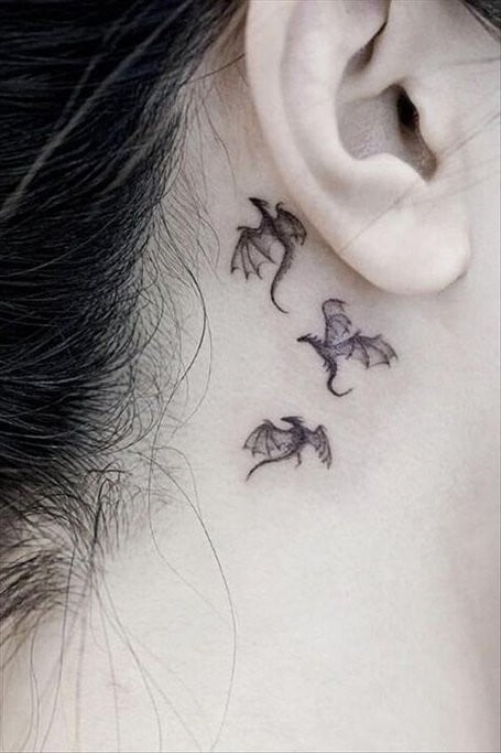 Tattoos behind the ears Three flying dragons