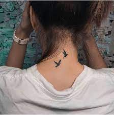 Tattoos on the nape of the neck two birds flying
