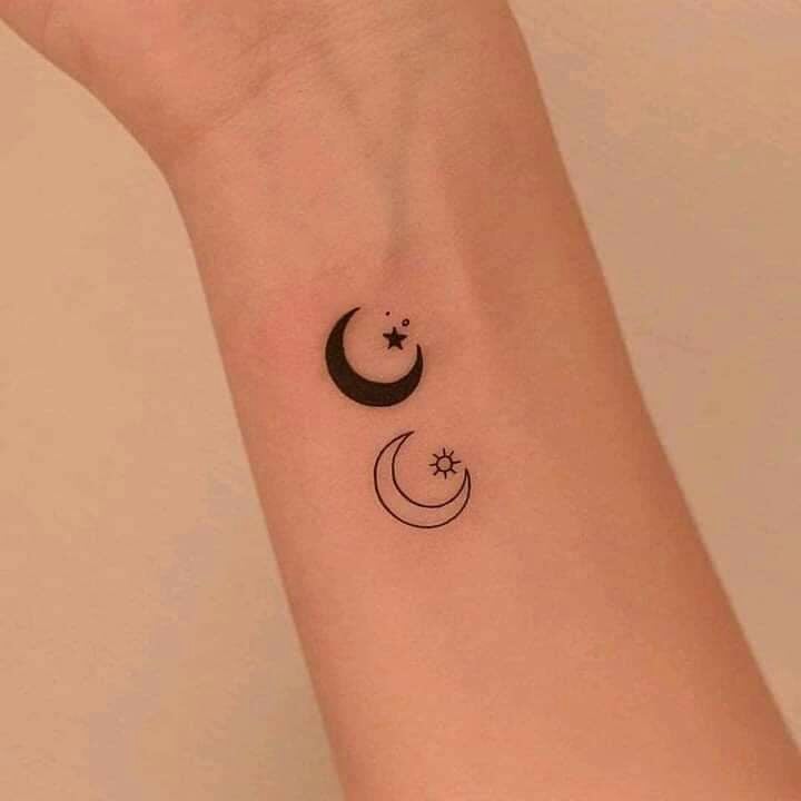 Kleine minimalistische Tattoos mit gefülltem Mond und ungefülltem Mond mit Sonne und Sternen am Handgelenk