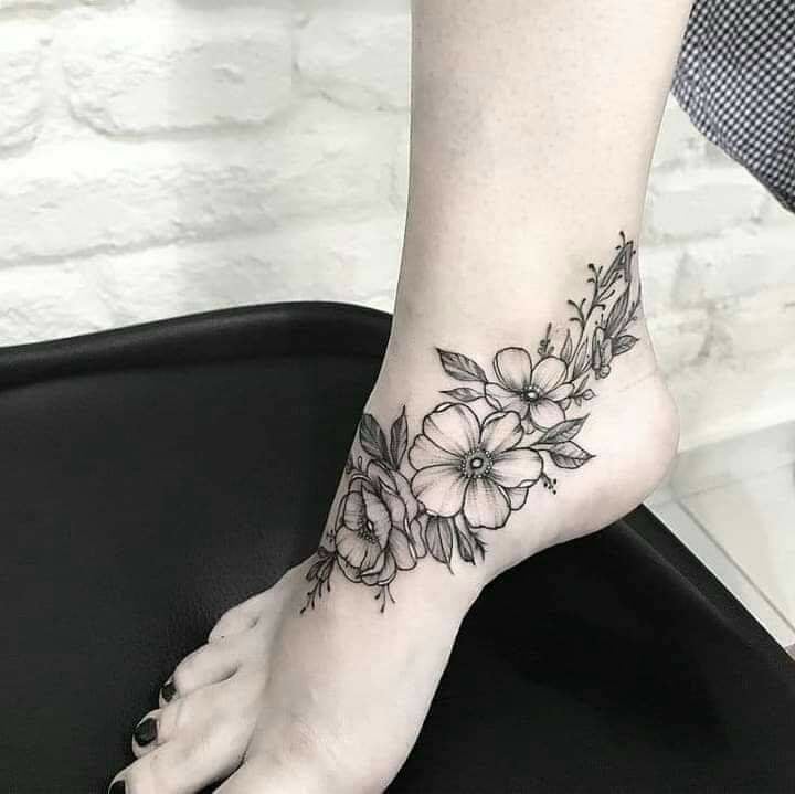 Tattoos for women flower arrangement motif on foot