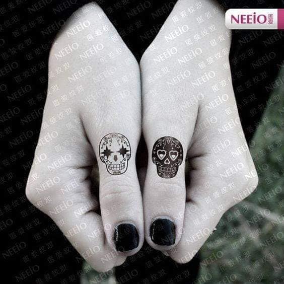 Tattoos for friends sisters couples white skull and black skull on both thumbs
