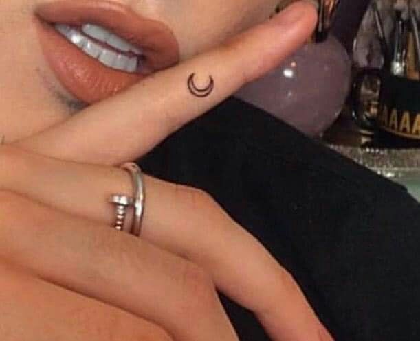 Tattoos for women a moon on the small finger