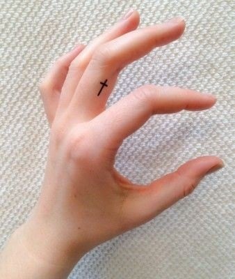 Small tattoos women cross on finger