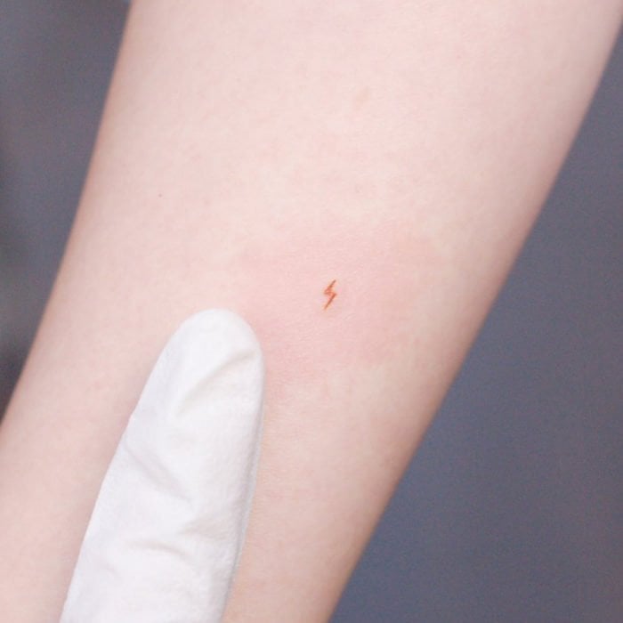 Super small tattoos for women tiny orange lightning bolt