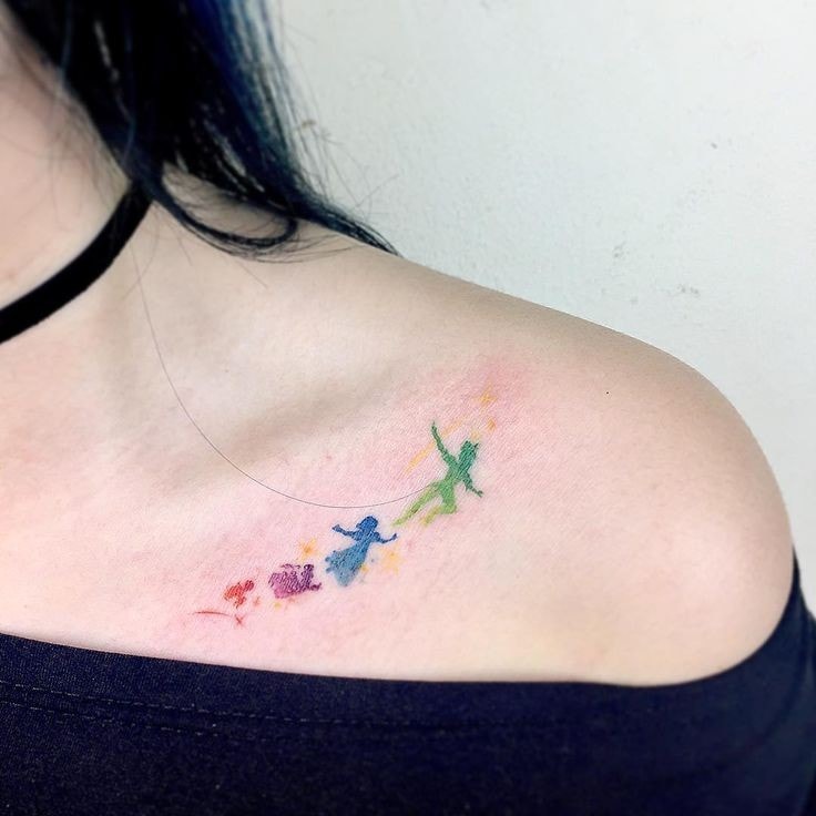 Tattoo on shoulder blade of a woman Peter Pan in delicate colors