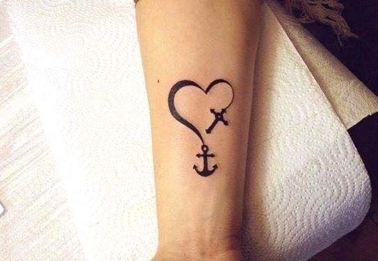 tattoo on the forearm area cross and anchors